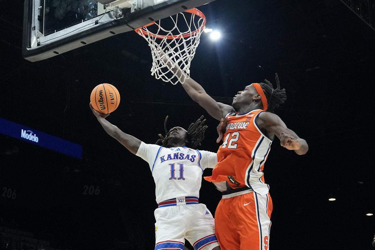 Jamari McDowell #11 of the Kansas Jayhawks shoots against William Kyle III #42 of the Syracuse Orange in the first half of their game during the Players Era Championship basketball tournament at Grand Garden Arena on November 25, 2025 in Las Vegas.