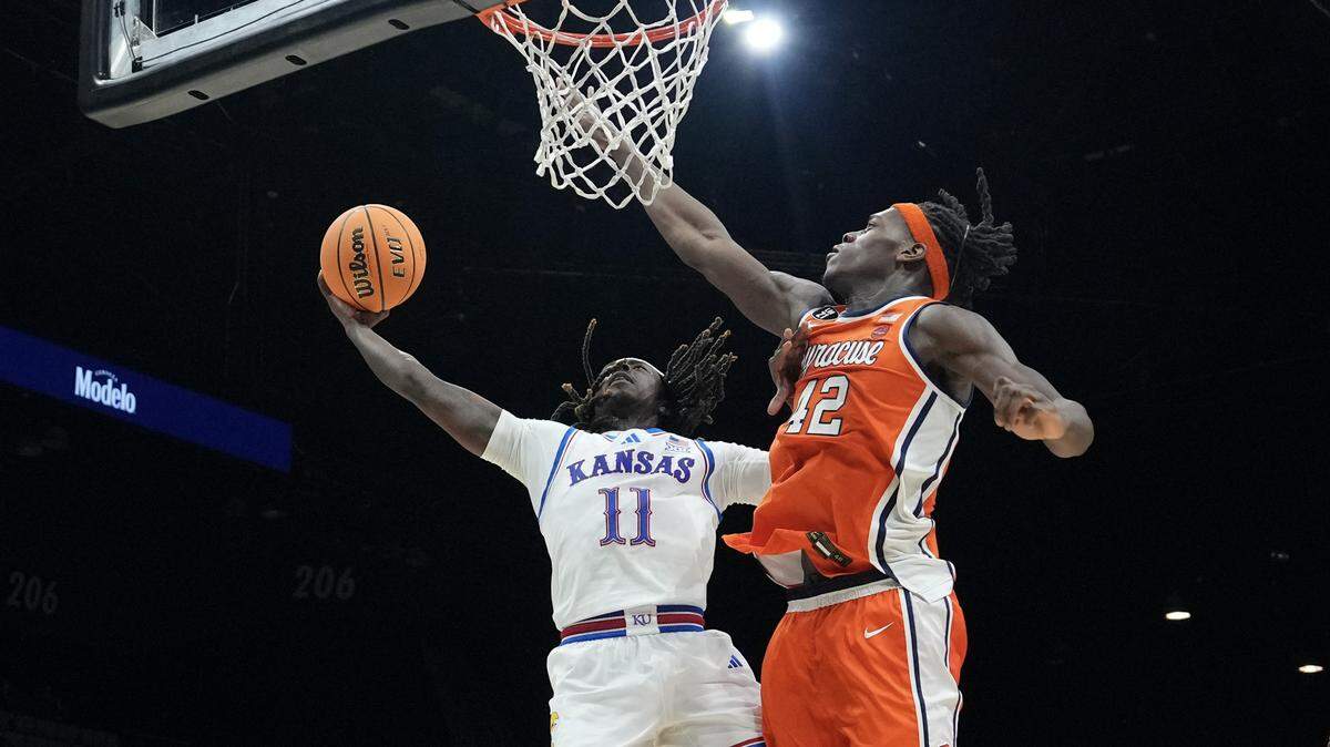Jamari McDowell #11 of the Kansas Jayhawks shoots against William Kyle III #42 of the Syracuse Orange in the first half of their game during the Players Era Championship basketball tournament at Grand Garden Arena on November 25, 2025 in Las Vegas.
