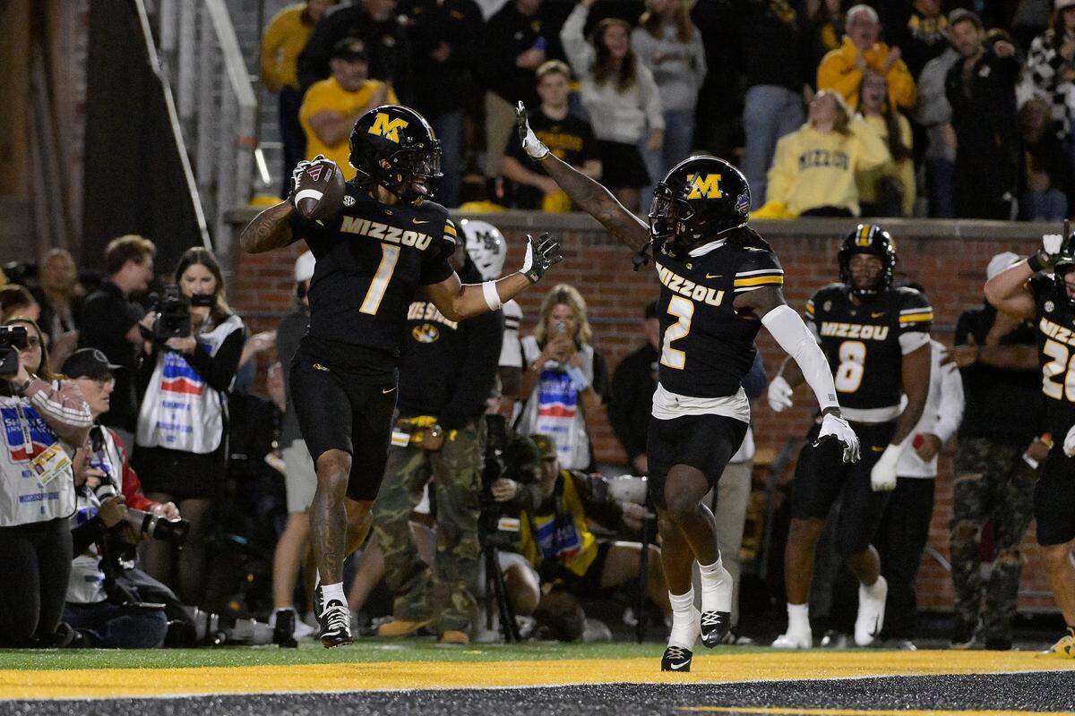 Marvin Burks #1 of the Missouri Tigers reacts with Toriano Pride Jr. #2 after returning and interception for a touchdown against the Mississippi State Bulldogs during the fourth quarter at Faurot Field at Memorial Stadium on November 15, 2025 in Columbia.