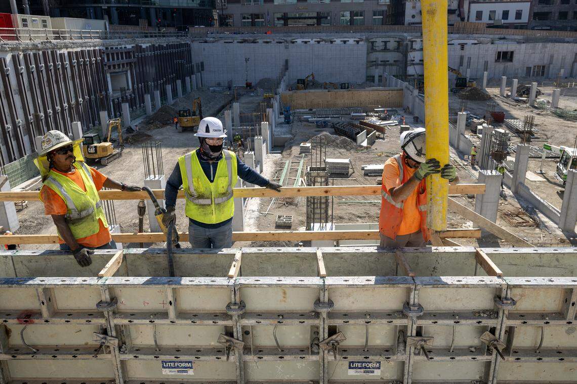 Workers pour concrete in August to form the new west wall of the Barney Allis Plaza parking garage.