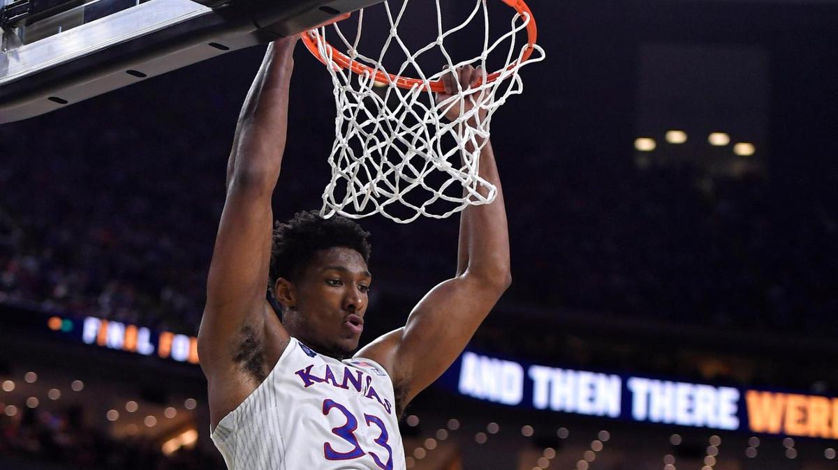 KU coach Bill Self, rear, applauds a dunk by David McCormack during the second half of Saturday’s NCAA national semifinal at the Final Four at the Superdome in New Orleans. KU beat Villanova, 81-65.