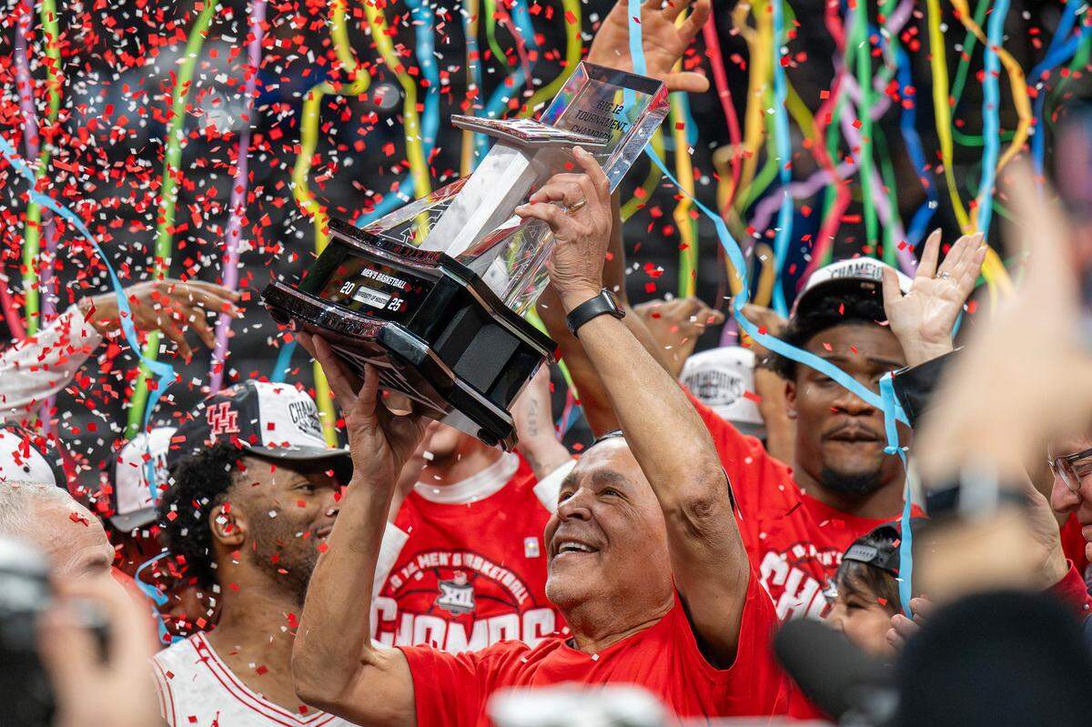 Houston coach Kelvin Sampson smiles as he hoists the Big 12 Championship trophy after a 72-64 victory Arizona in the Big 12 Tournament finals. Houston is the No. 1 seed in the men’s NCAA Tournament Midwest Regional.