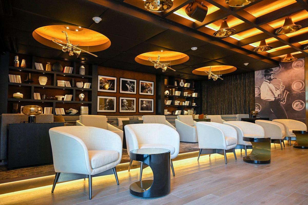 Jazz-inspired decor surrounds the Blue Note theater room at Three Light Luxury Apartments.