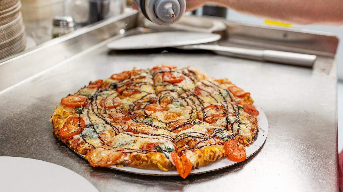 The Margherita pizza at PaPPo’s: olive oil glaze, light red sauce, mozzarella & swiss cheese, chopped fresh basil, feta cheese, fresh tomatoes & balsamic reduction sauce drizzled on top.