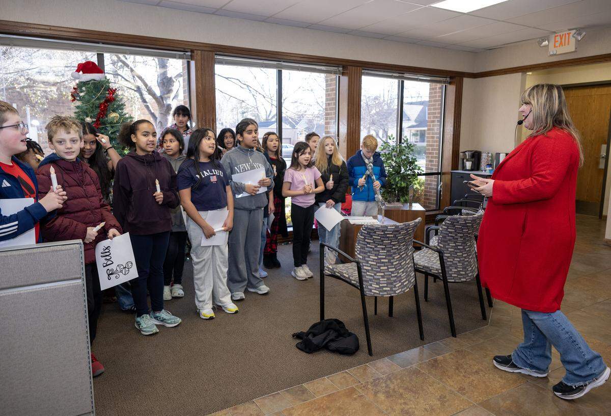 Under the direction of music teacher Rachel Marlow, special chorus students from Central Elementary School in Olathe, sing holiday carols at Mainstreet Credit Union in Downtown Olathe on Wednesday, Dec. 17, 2025.