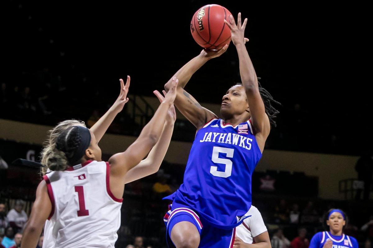Kansas Guard Aniya Thomas (5) takes a contested shot over Oklahoma defenders during the Women’s Big 12 Tournament game between the Kansas Jayhawks and the Oklahoma Sooners on March 11, 2022 at Municipal Auditorium in Kansas City, MO