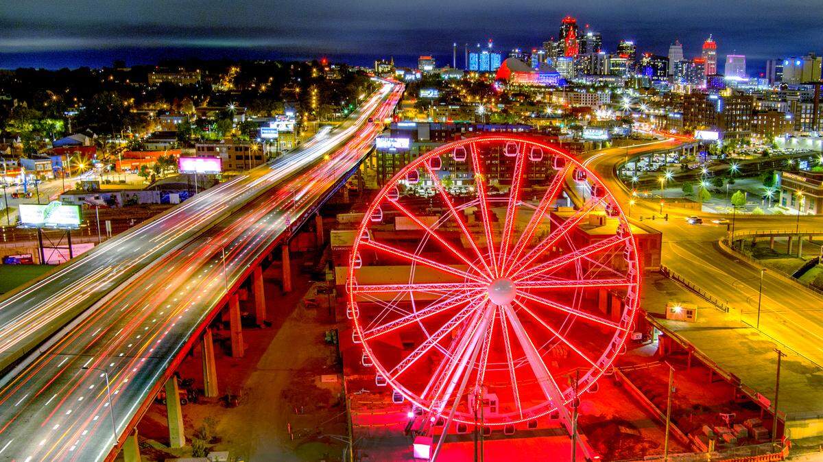 The 150-foot tall Ferris wheel glows in the night at Pennway Point at the nearly 6-acre entertainment district being developed by 3D Development of Kansas City.