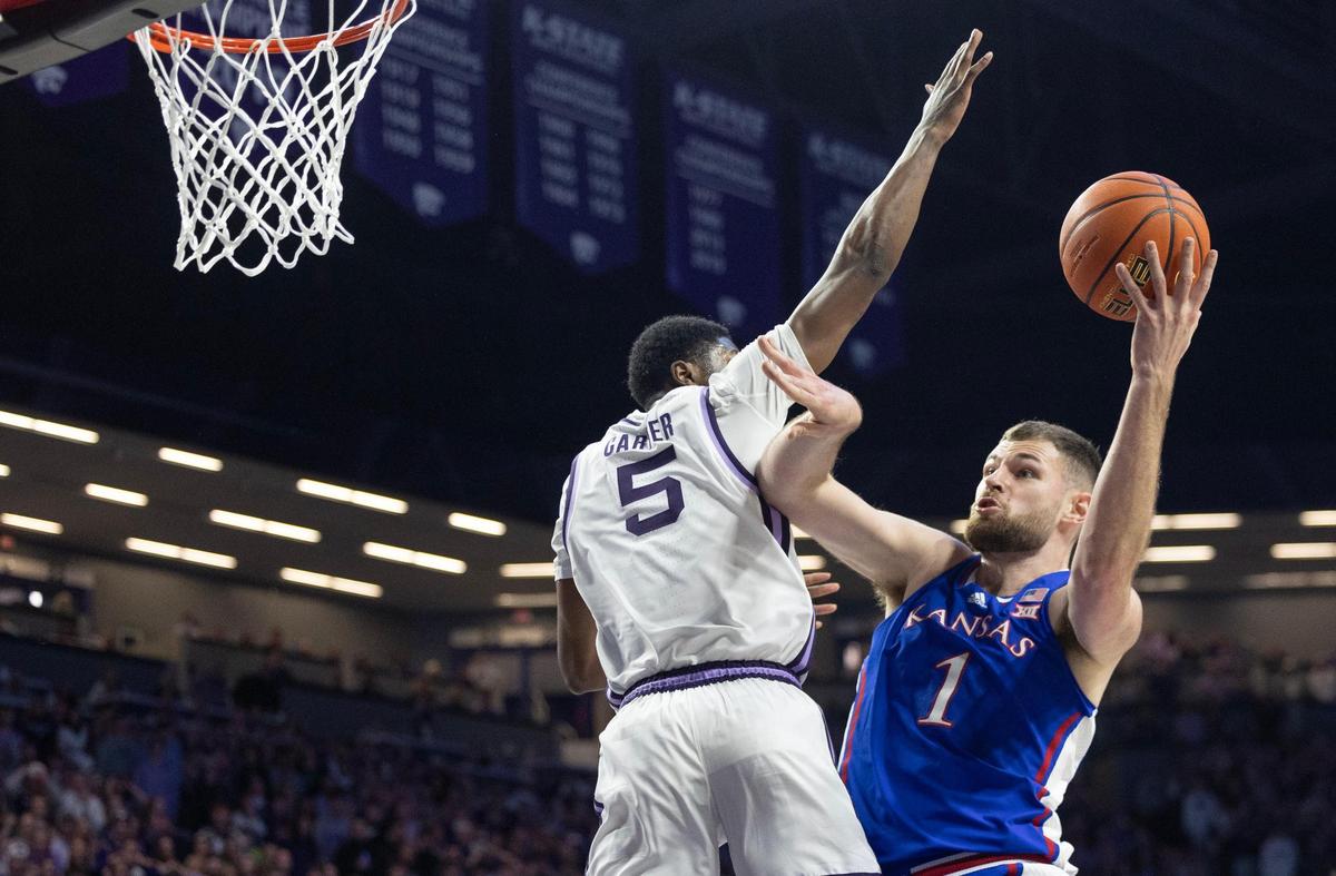 Kansas’ Hunter Dickinson takes a shot against Kansas State’s Cam Carter during the first half of their game in Manhattan on Monday night.