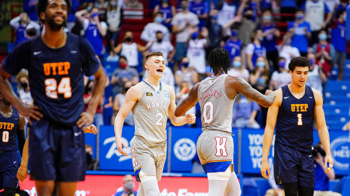 Kansas guard Christian Braun (2) comes to congratulate Kansas guard Marcus Garrett (0) after the Jayhawks pulled off a 67-62, comeback win over UTEP on what would be Garrett’s final game at Allen Fieldhouse, Thursday, March 4, 2021.