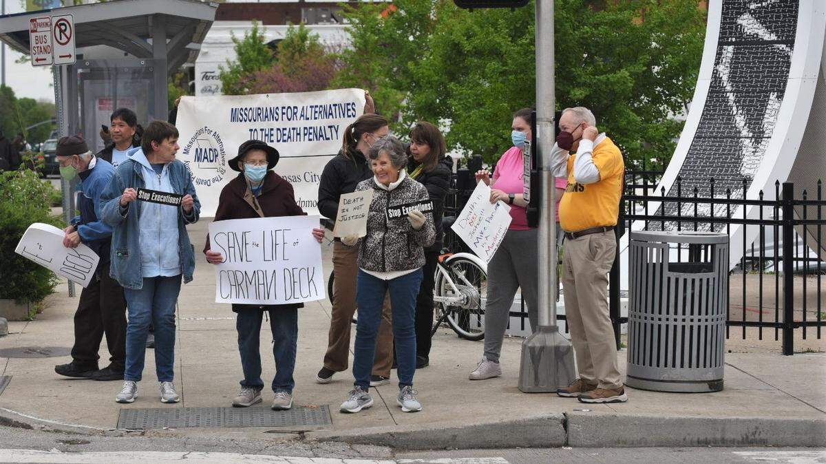 About a dozen protesters gathered at Troost Avenue and 39th Street ahead of the impending execution of Carman Deck, a 56-year-old man convicted of murdering two people in eastern Missouri. Deck died at 6:10 p.m. by lethal injection at a state prison.
