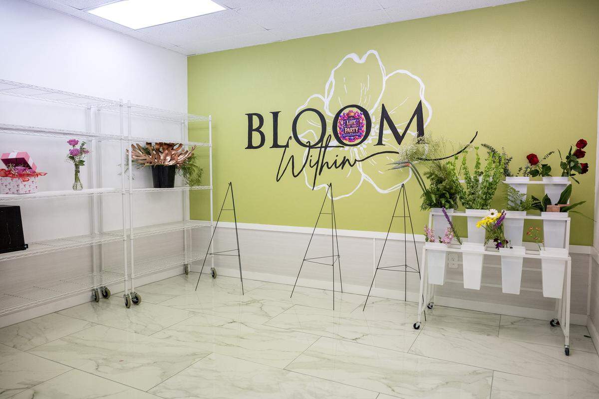 The holding tank area with storage racks and a mural is seen at Pritzy Floral Design Studio on Thursday, Jan. 8, 2026, in Grandview.