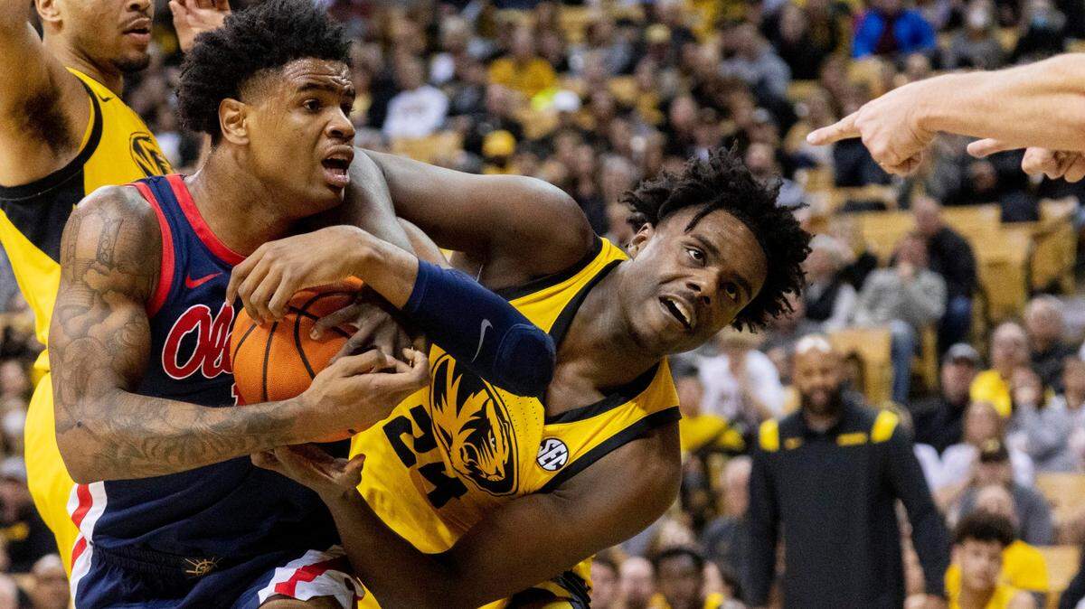 Mississippi’s Luis Rodriguez, left, and Kobe Brown, right, look at a referee as a jump ball is called during the first half of an NCAA college basketball game Saturday, Feb. 12, 2022, in Columbia, Mo. (AP Photo/L.G. Patterson)