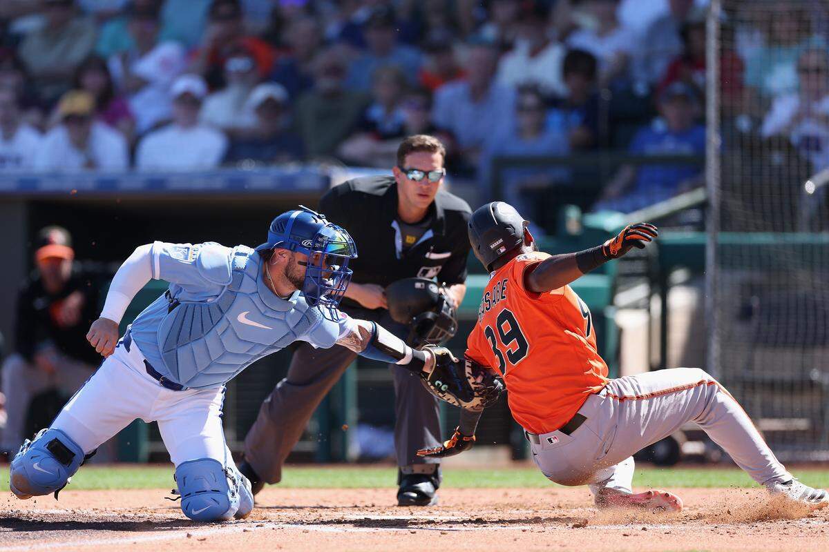 Kansas City Royals catcher Carter Jensen tags out San Francisco Giants prospect Osleivis Basabe attempting to score during the third inning of the spring training game at Surprise Stadium on March 11, 2026 in Surprise, Arizona.