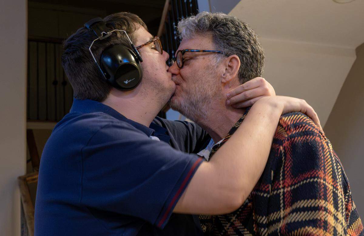 Berry Long embraces and kisses his son, Harrison, at their home on Tuesday, Feb. 10, 2026, in Parkville.