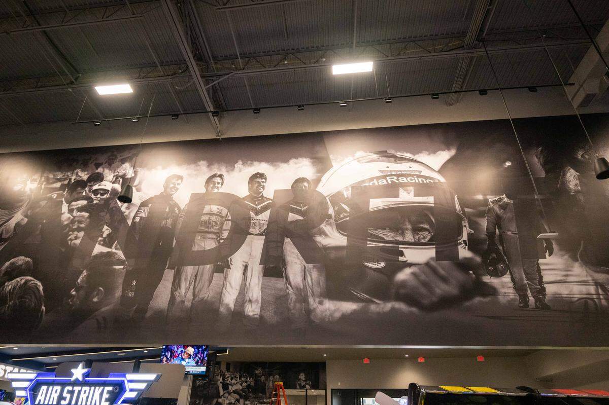 A wall covering featuring the Andretti family at the newest location of Andretti Indoor Karting and Games.