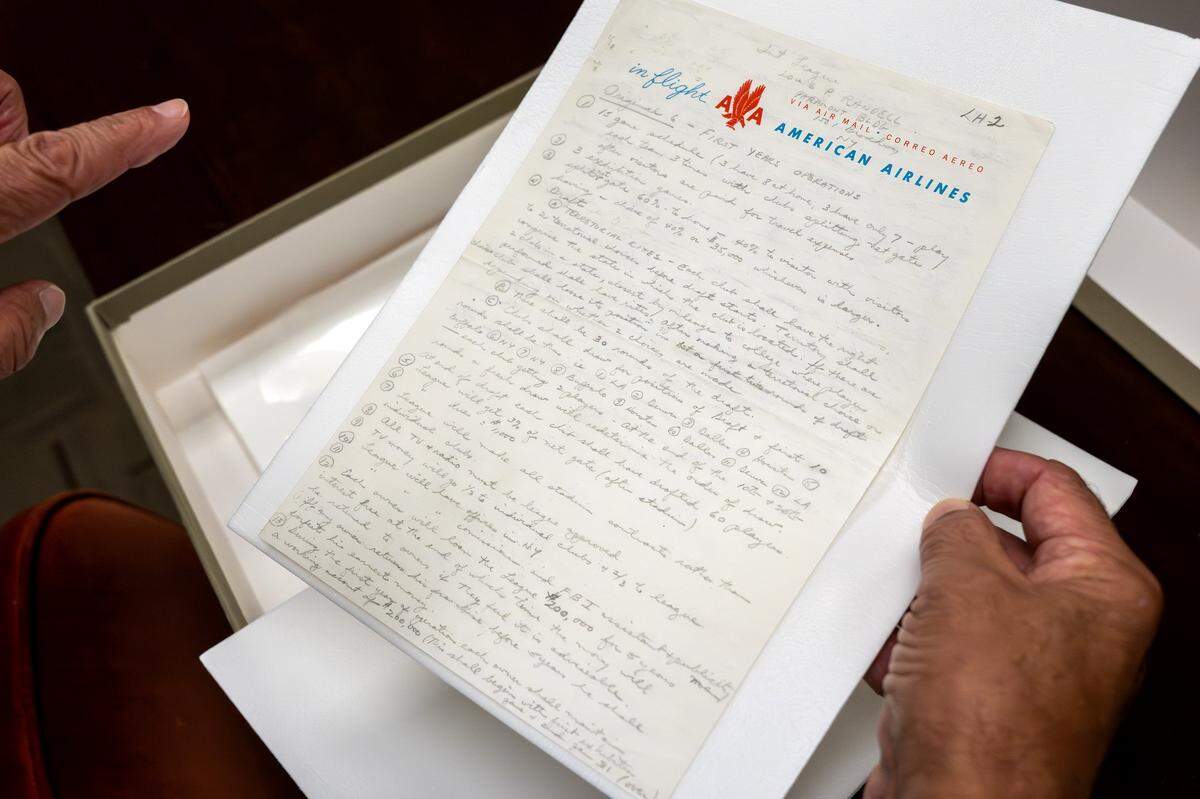 Historian Mike Davidson displays a note handwritten by Kansas City Chiefs founder Lamar Hunt (on American Airlines stationery, because he was on a flight at the time) inside the team’s underground storage facility in Kansas City.