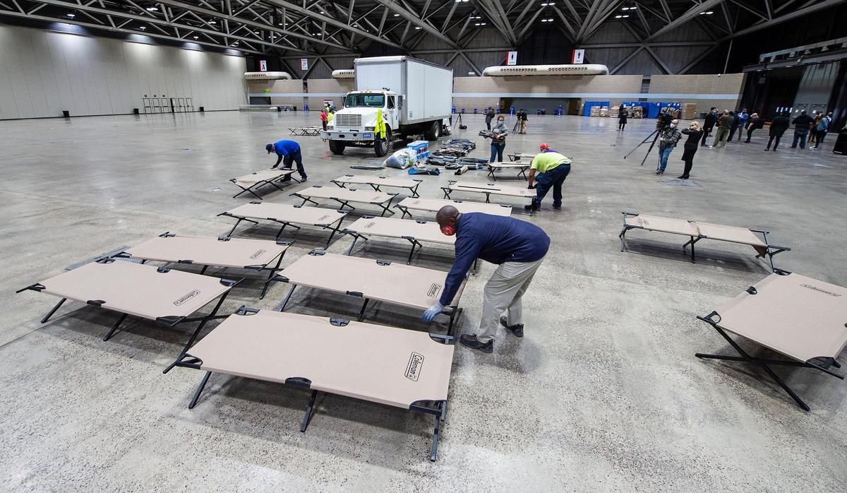 The floor of Bartle Hall was being transformed into a warming shelter for homeless people Friday as city workers assembled cots in the main exhibition hall. The opening of the shelter was announced by city officials Friday. It will be a place for people to get off the streets from 6 p.m. to 8 a.m. through March 31.