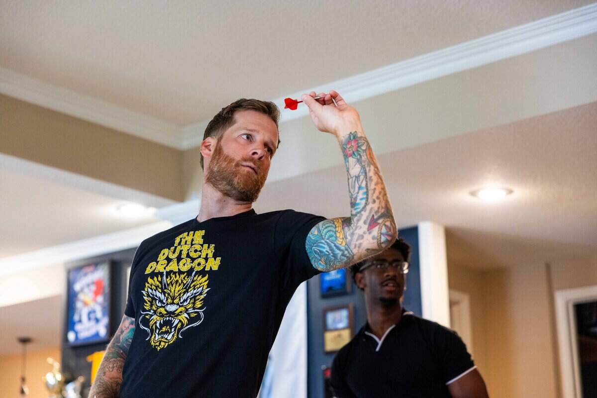 Professional darts player Jules van Dongen demonstrates his technique for The Star’s Christian Marshall at his home on Saturday, June 13, 2026.
