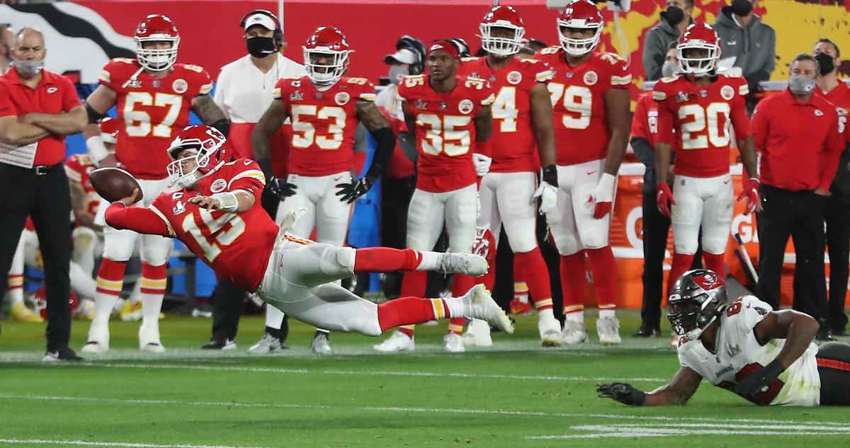 Kansas City Chiefs quarterback Patrick Mahomes is tripped up by Tampa Bay Buccaneers defensive end William Gholston and flies through the air as he gets off a pass to the end zone in the fourth quarter Sunday, February 7, 2021, at Super Bowl LV at Raymond James Stadium in Tampa, Florida. The pass was incomplete.