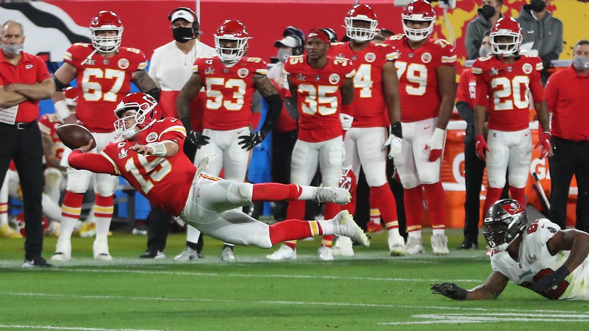 Kansas City Chiefs quarterback Patrick Mahomes is tripped up by Tampa Bay Buccaneers defensive end William Gholston and flies through the air as he gets off a pass to the end zone in the fourth quarter Sunday, February 7, 2021, at Super Bowl LV at Raymond James Stadium in Tampa, Florida. The pass was incomplete.