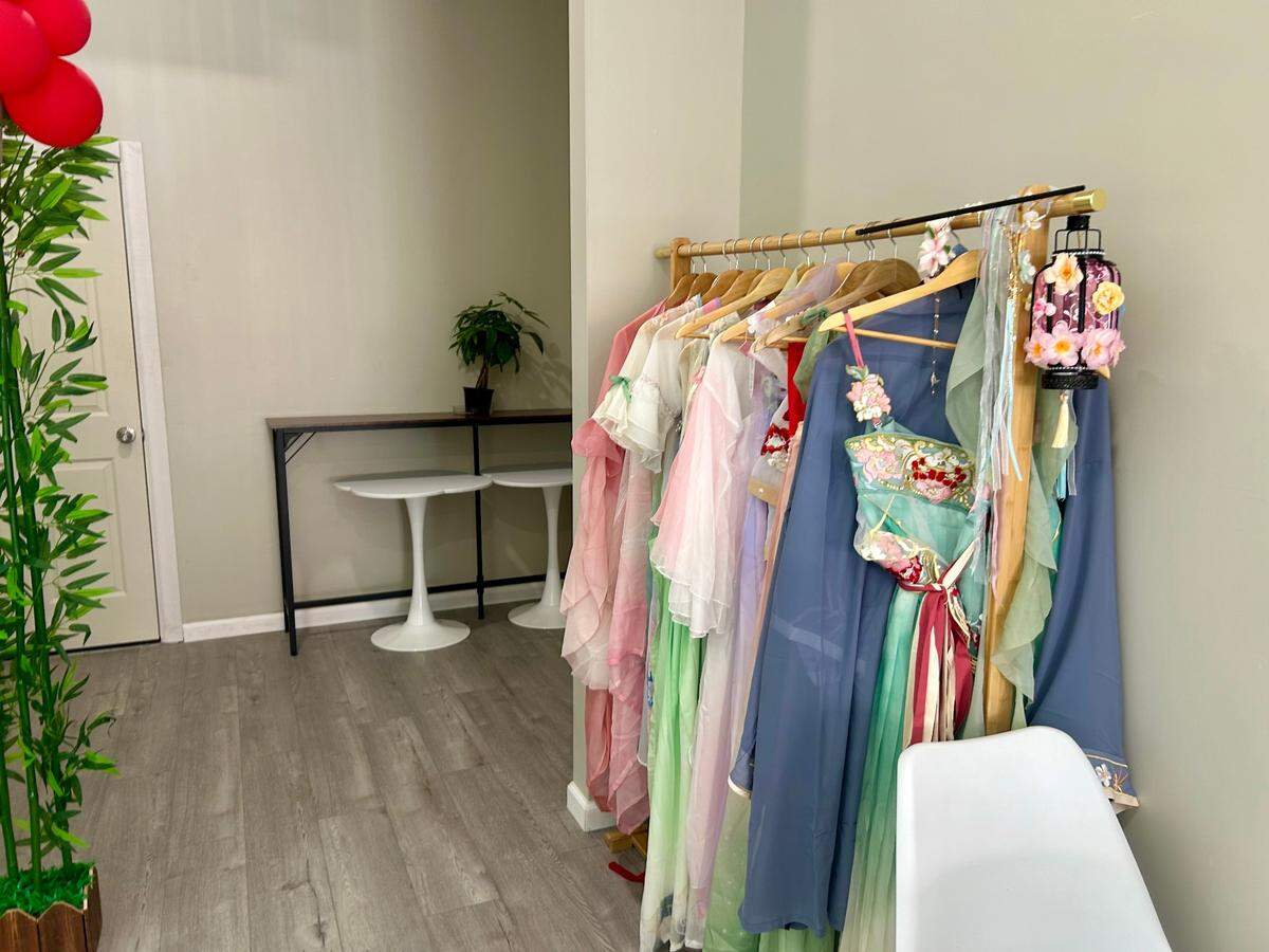 Flower Tea has a rack of traditional Chinese garments hanging in the back of its store.