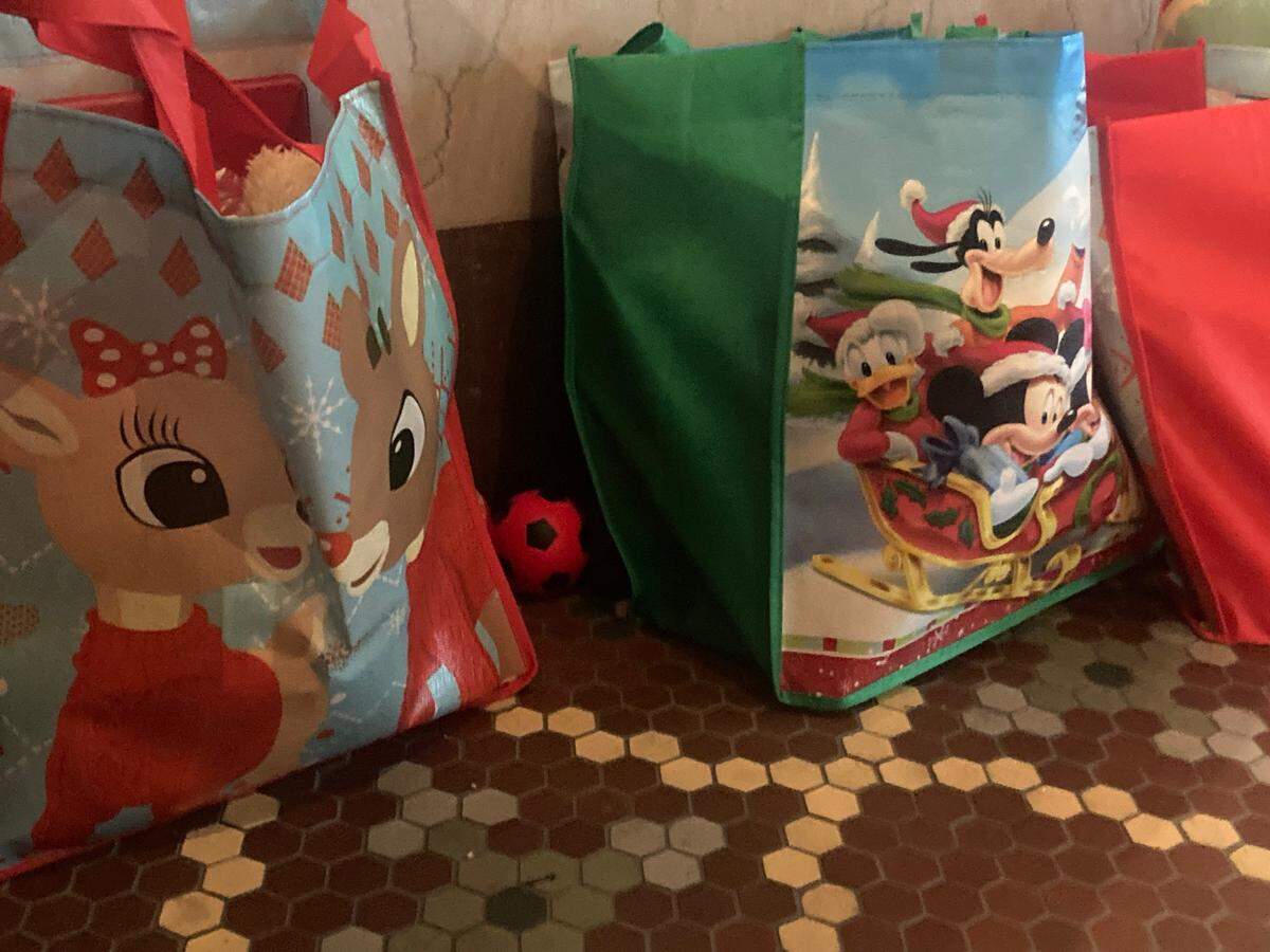 Gift bags for the 30 Santas and Mrs. Clauses attending the Santa America symposium at The Hotel Savoy in Kansas City contain books and stickers and stuffed toys, as opposed to candy, that Santa’s may want to give to the children they see.