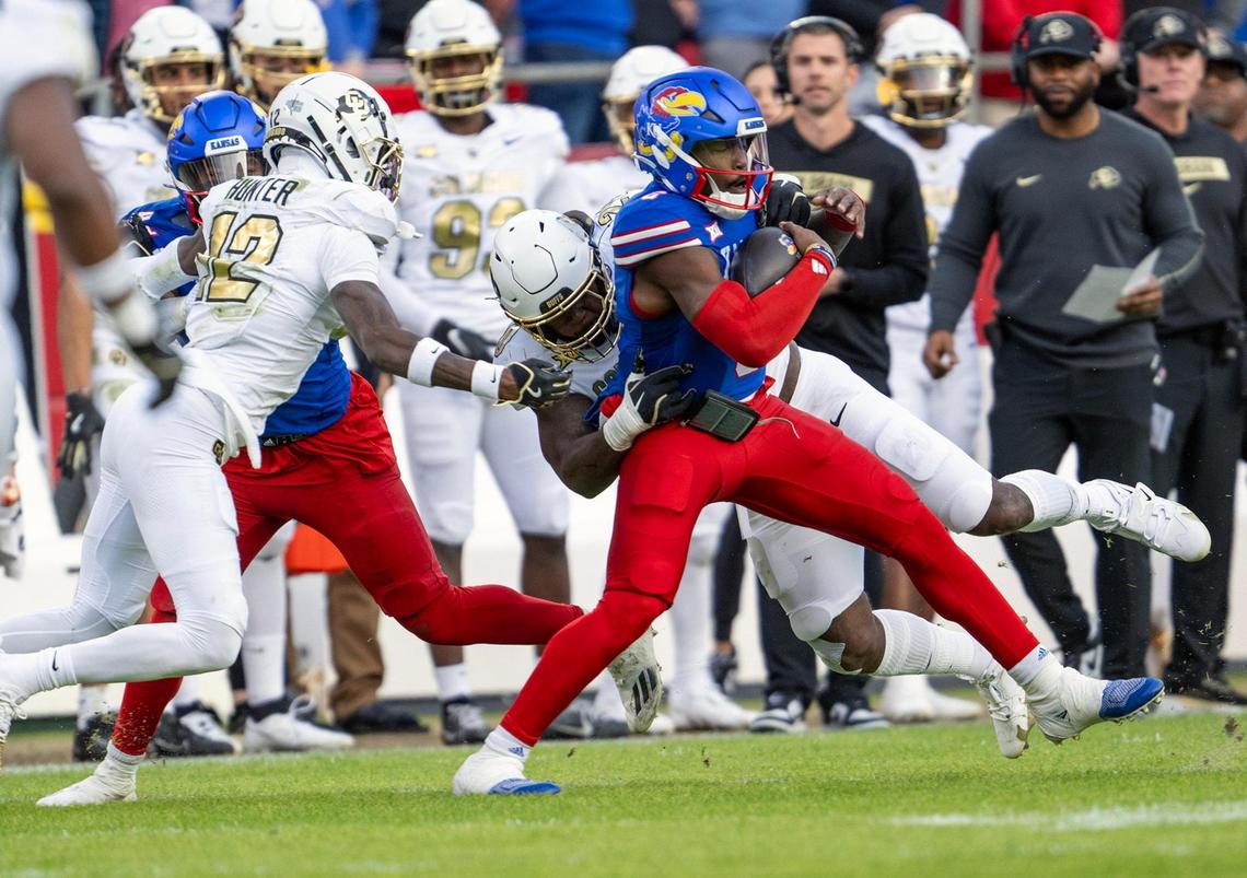 Colorado Buffaloes defensive back Travis Hunter (12) pursues Kansas Jayhawks quarterback Jalon Daniels (6) during the first half at GEHA Field at Arrowhead Stadium on Saturday, Nov. 23, 2024, in Kansas City.