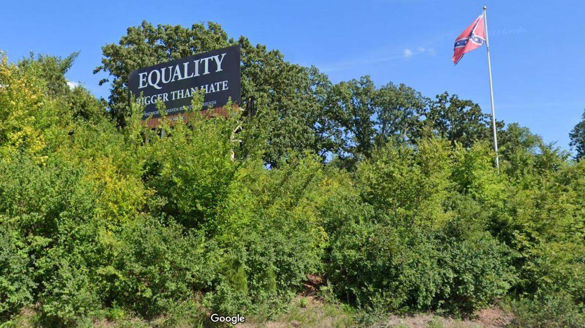 In 2021, Amanda Burrows started raising funds to lease both sides of a billboard with the anti-racism message “EQUALITY BIGGER THAN HATE” in response to a giant Confederate flag erected along U.S. 54 highway, just south of Eldon, Missouri. The Missouri Conference of the United Methodist Church will take over the billboard spaces with its own message of “HATE DIVIDES LOVE UNITES.” This Google Maps Street View image of the area is from 2023.