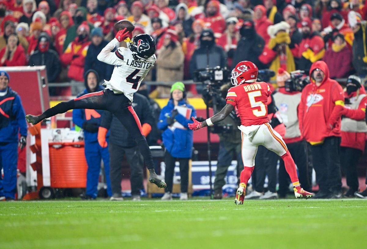 Houston Texans cornerback Kamari Lassiter (4) catches a pass meant for Kansas City Chiefs wide receiver Marquise Brown (5) in the second half of the game GEHA Field at Arrowhead Stadium on Sunday, Dec. 7, 2025, in Kansas City.