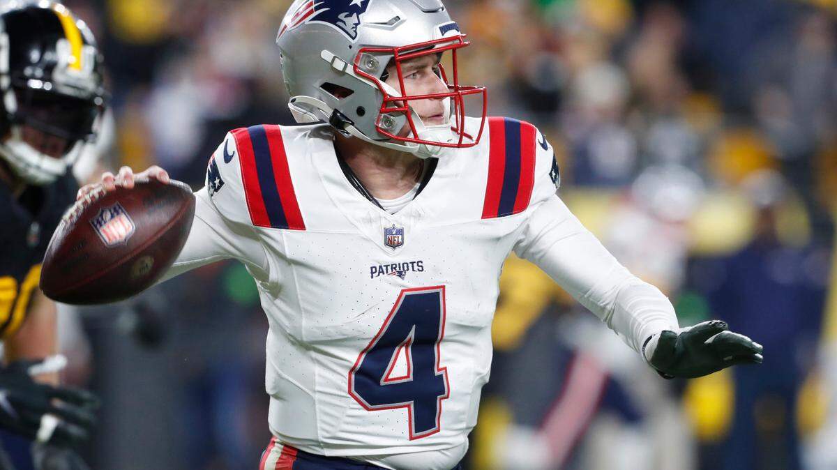 New England Patriots quarterback Bailey Zappe throws on the run against the Pittsburgh Steelers during the third quarter at Acrisure Stadium. New England won 21-18.