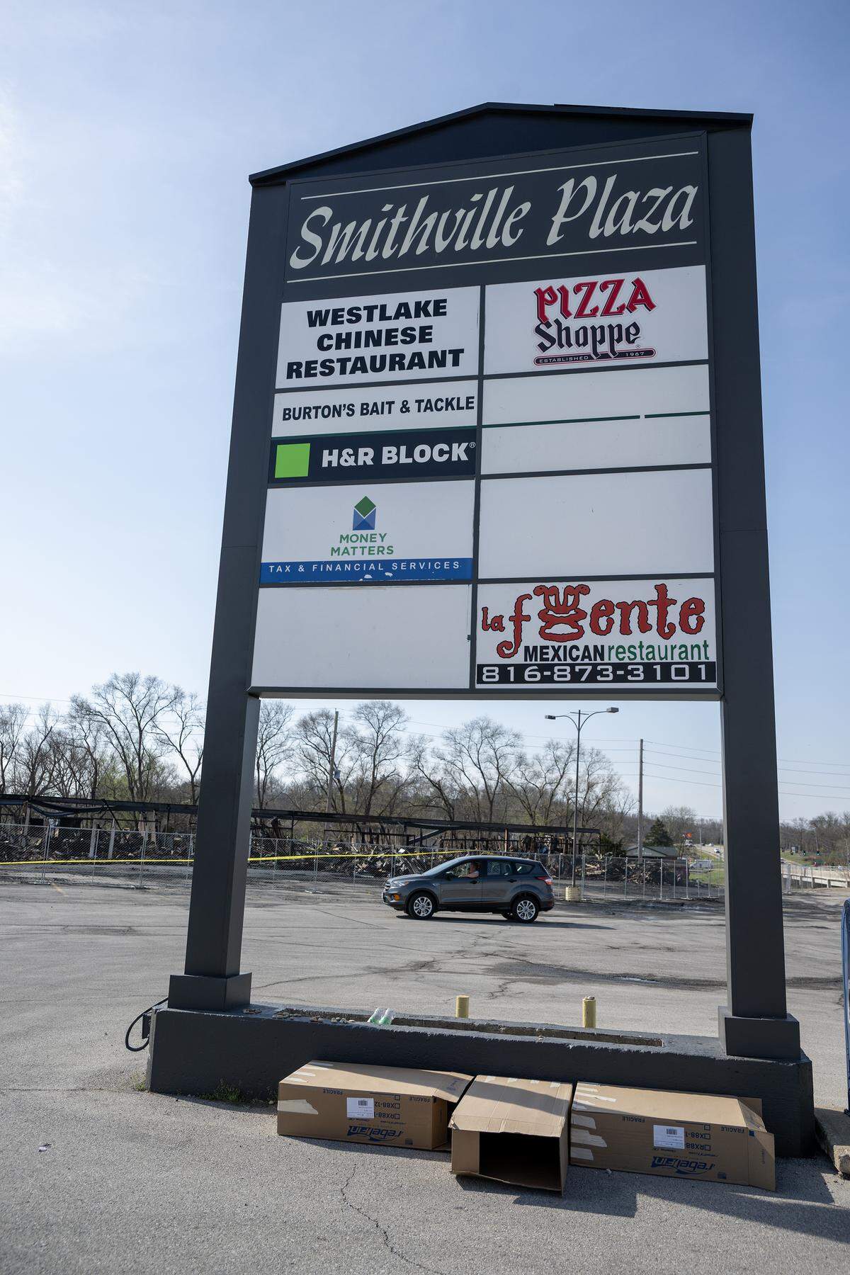 The skeletal remains of a Smithville shopping center are seen behind a marquee sign and stand in ruin on Tuesday, March 31, 2026, less than 24 hours after a massive fire destroyed five businesses. The Monday afternoon blaze destroyed Smithville’s Pizza Shoppe, La Fuente Mexican Restaurant, H&R Block, Westlake Chinese Restaurant, and Lakeside Smoke.