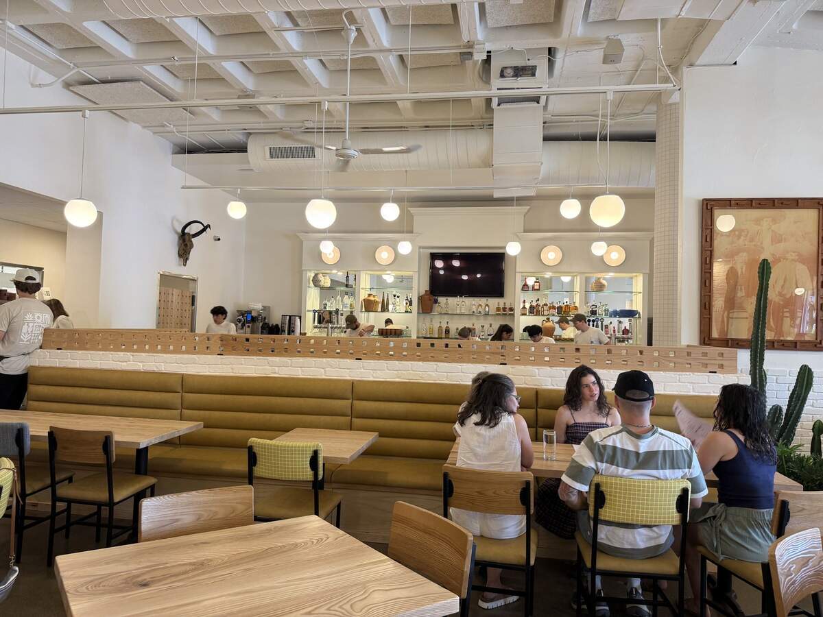 Spherical light fixtures, ceramics and cacti adorn the space.