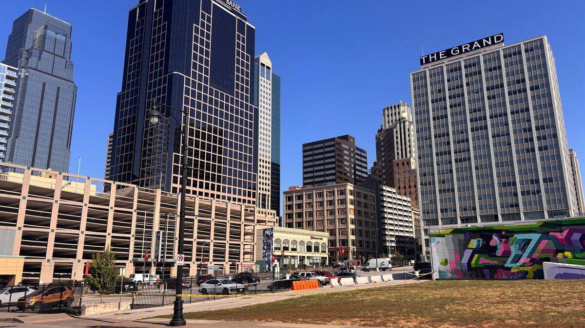 Police tape remained up Sunday morning after two people were killed in a shooting in a downtown Kansas City parking lot at 13th and Grand.