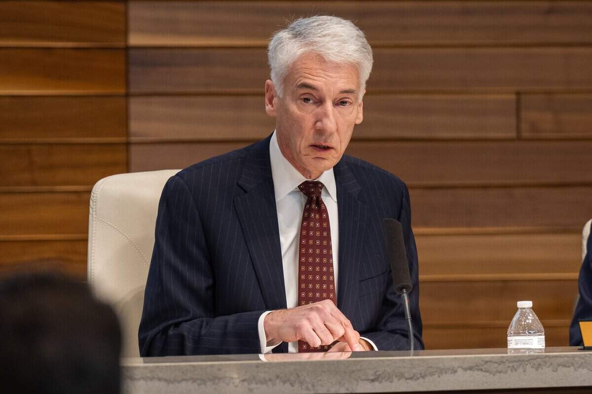 Board President Tom Whittaker speaks to a member of KCPD during the Kansas City Board of Police Commissioners January meeting on Tuesday, January 27, 2026, at KCPD Headquarters.