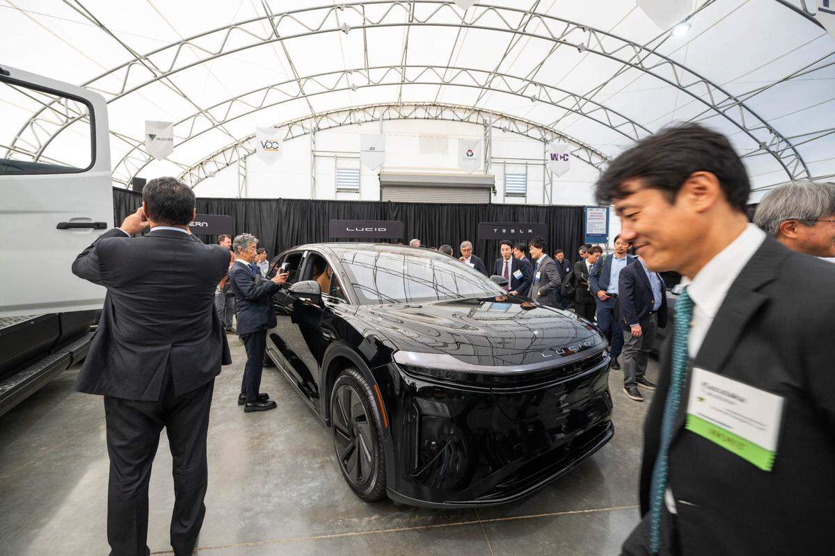 Attendees took closer looks at a Lucid Gravity, one of the electric vehicles that will use Panasonic batteries, during the grand opening of the new Panasonic electric vehicle battery plant on Monday, July 14, 2025 in De Soto, Kansas.
