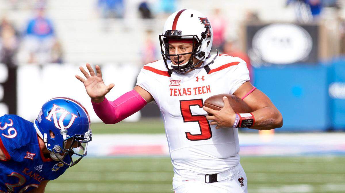 Texas Tech quarterback Patrick Mahomes, right, scrambles during a game against KU at David Booth Kansas Memorial Stadium.