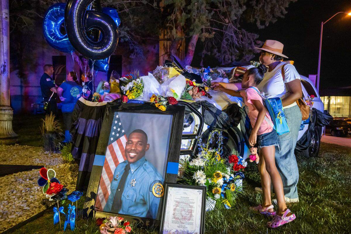 The cruiser of slain KCK sheriff’s deputy Elijah Ming is decorated as a memorial outside the Wyandotte County Courthouse on Wednesday, July 30, 2025. The nearly nine-year veteran died in the line of duty on Saturday, July 26, 2025.