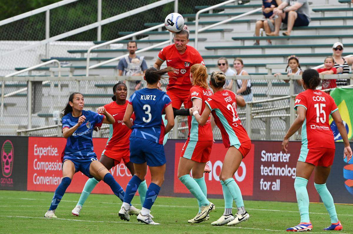 Kansas City Current defender Hailie Mace rises from the crowd for a header during Sunday’s NWSL match against the North Carolina Courage at WakeMed Soccer Park.