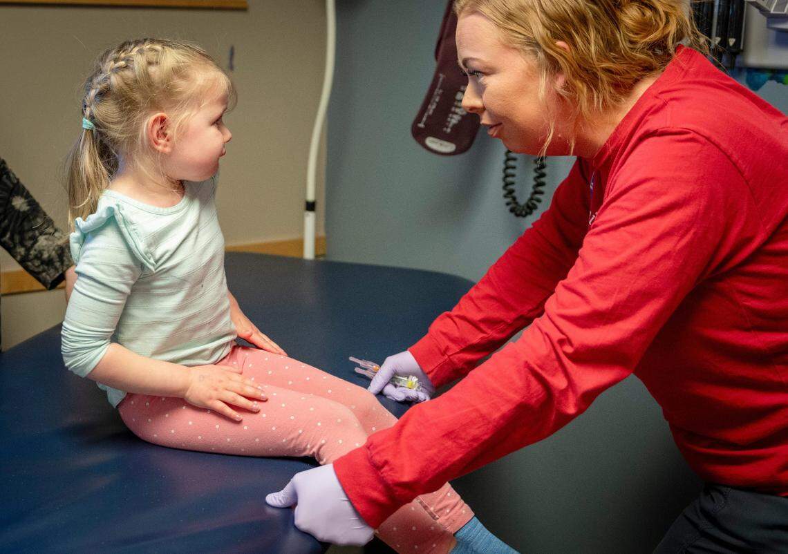 A 4-year-old child gets the MMR vaccine in Des Moines. Children usually get two doses of the MMR vaccine, but some states are now suggesting a third infant dose.
