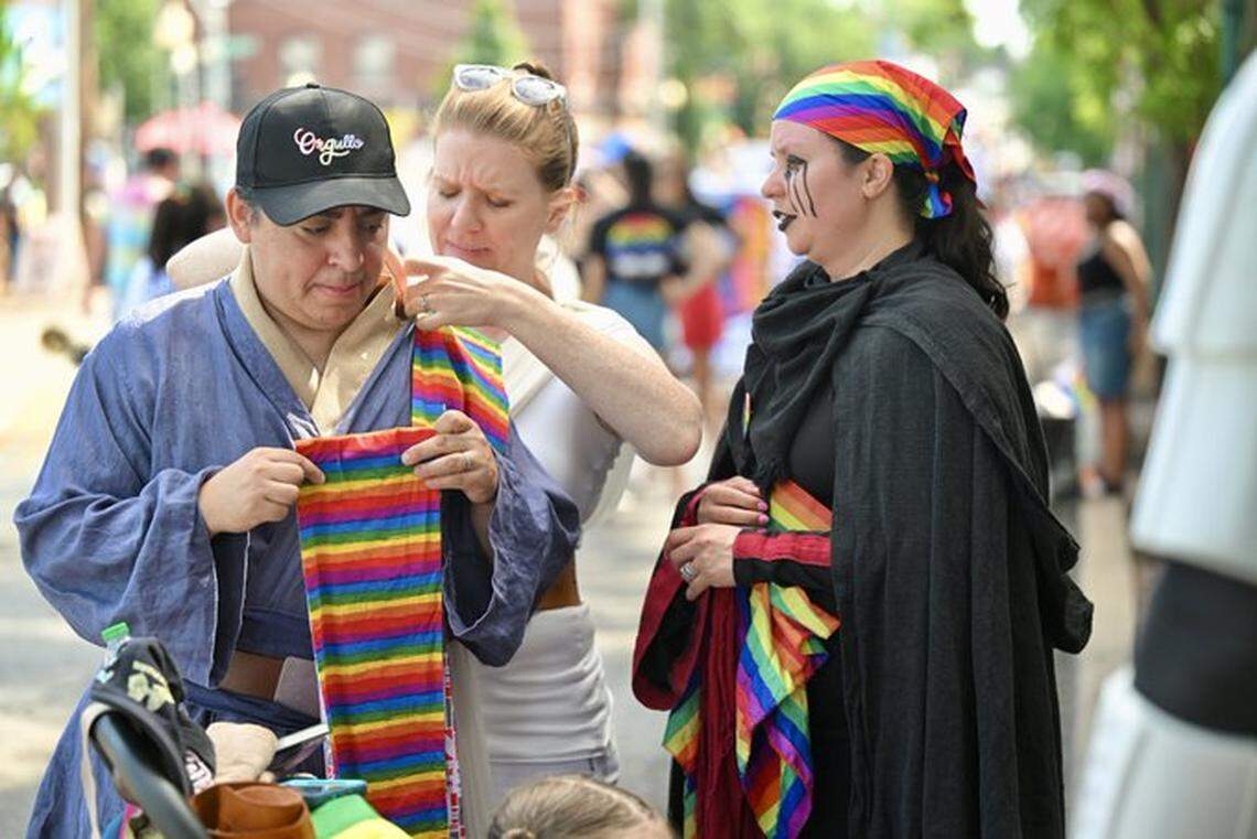 Brenda Linares, left, had her costume adjusted by her wife, Emily Vardell , of Olathe, as Sarah Thesman of Overland Park looked on at the KC Pride Parade on Saturday in Kansas City. The group was with the KC Star Wars Alliance.