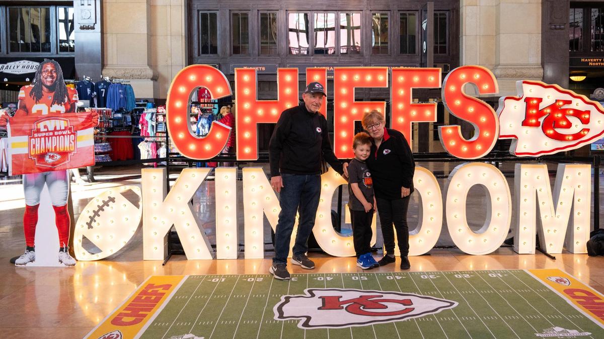 Tom and Debbie Harral with their grandson, Elliot, visit the newest Chiefs Fan Zone installment at Union Station in Kansas City on Thursday, Jan. 16, 2025.