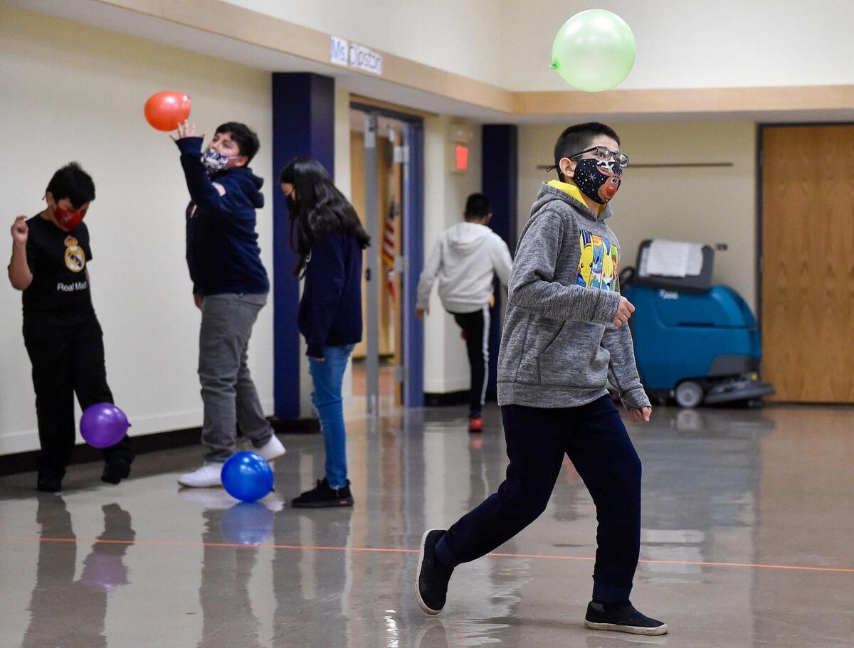In his physical education class, fifth grader Jonathan Marquez and other students use a balloon as a soccer ball. Students arrived at Douglass Elementary School in Kansas City, Kansas, Wednesday, March 31, 2021, for the first day of full in-person learning. According to Principal Louis Neal, about 75 percent of students are coming back for in-person learning.