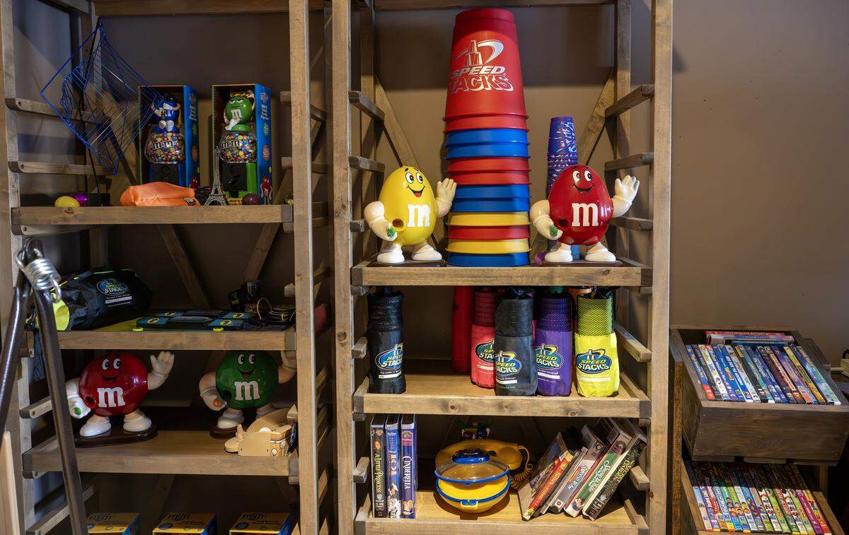 Harrison Long's collection of M&M's figurines and movies is displayed on shelves in his “man cave” at the Long home on Tuesday, Feb. 10, 2026, in Parkville.