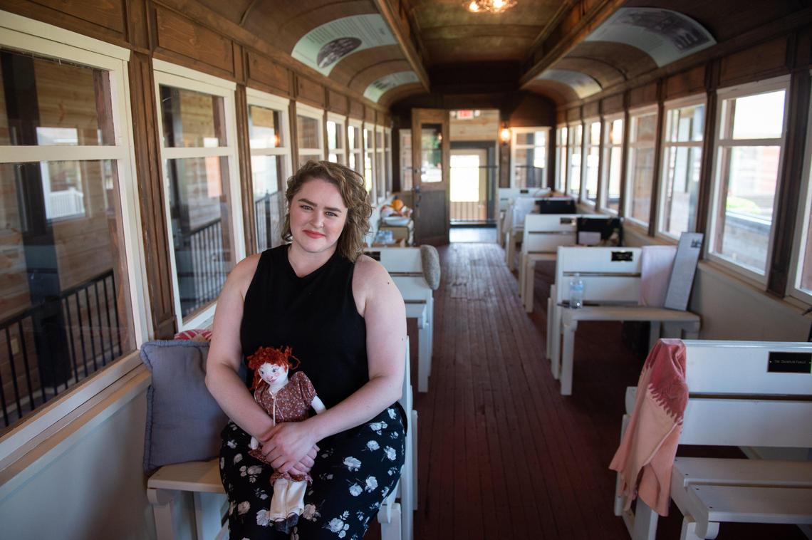 Shaley George, curator of the National Orphan Train Complex, sat inside a restored train car exhibit.