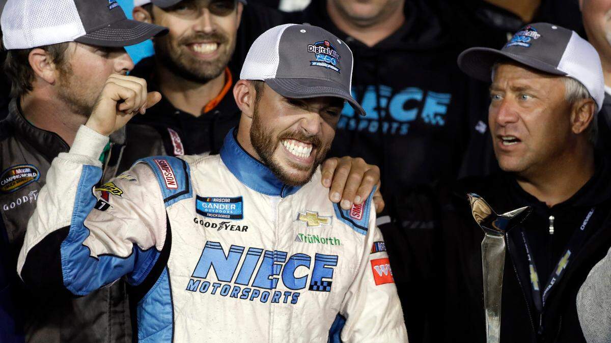 Ross Chastain celebrates in Victory Lane following the NASCAR Truck Series auto race at Kansas Speedway in Kansas City, Kan., Friday, May 10, 2019. (AP Photo/Colin E. Braley)