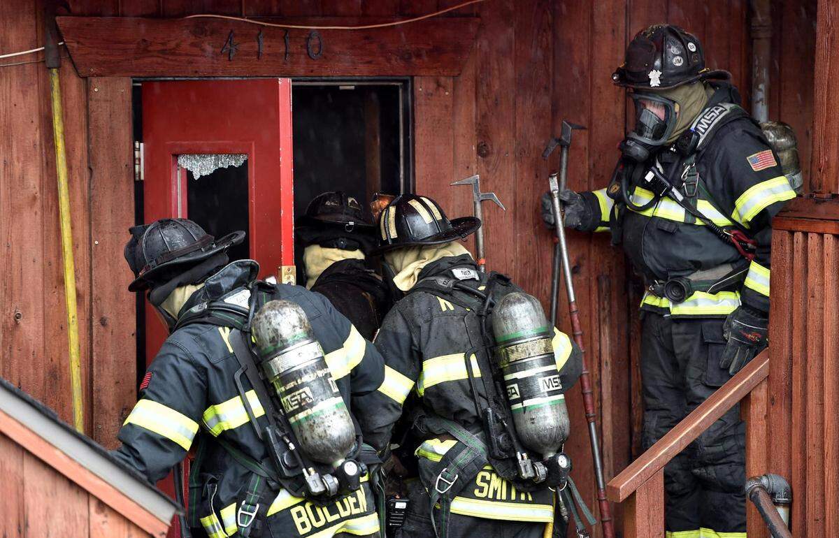 Fire crews enter the building at 4110 Pennsylvania Ave., in Westport to work on the fire.