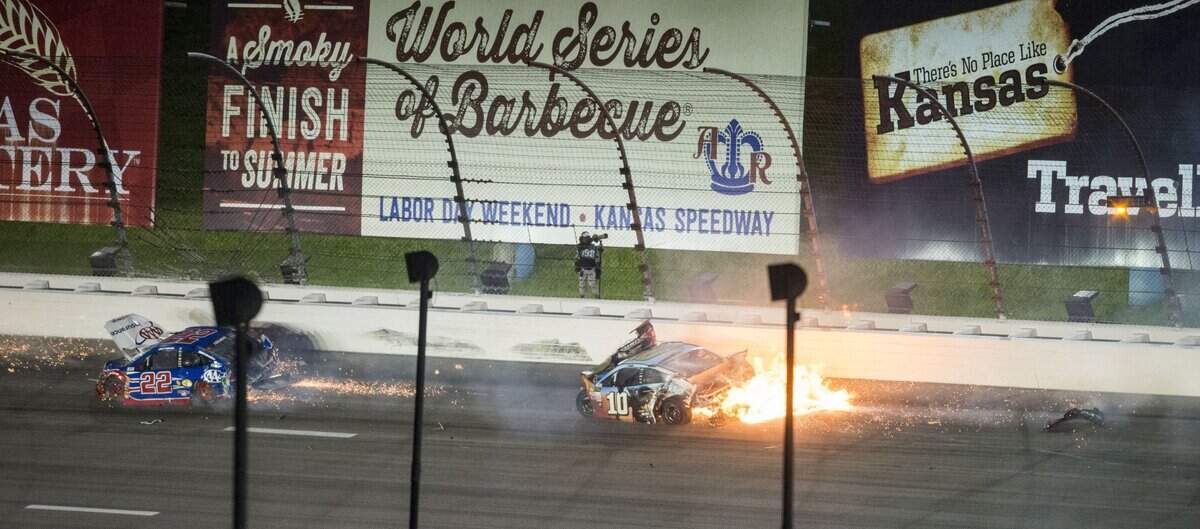 Sparks fly from Joey Logano’s No. 22 car, right, and Danica Patrick’s 10 car bursts into flames during the GoBowling 400 at Kansas Speedway on May 13, 2017.