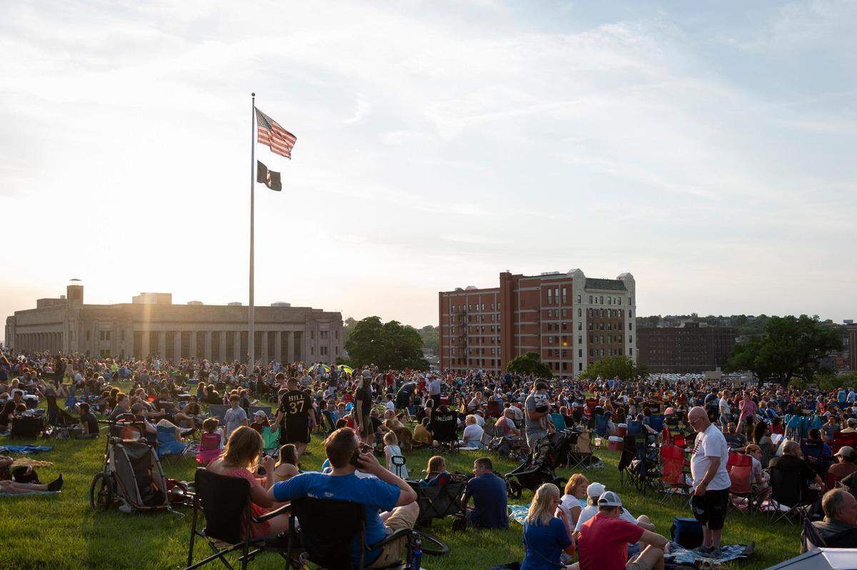 As the sun sets, crowds fill in the north lawn of the National WWI Museum and Memorial just before the start of the Bank America Celebration at the Station featuring the Kansas City Symphony on Sunday, May 29, 2022, in Kansas City.