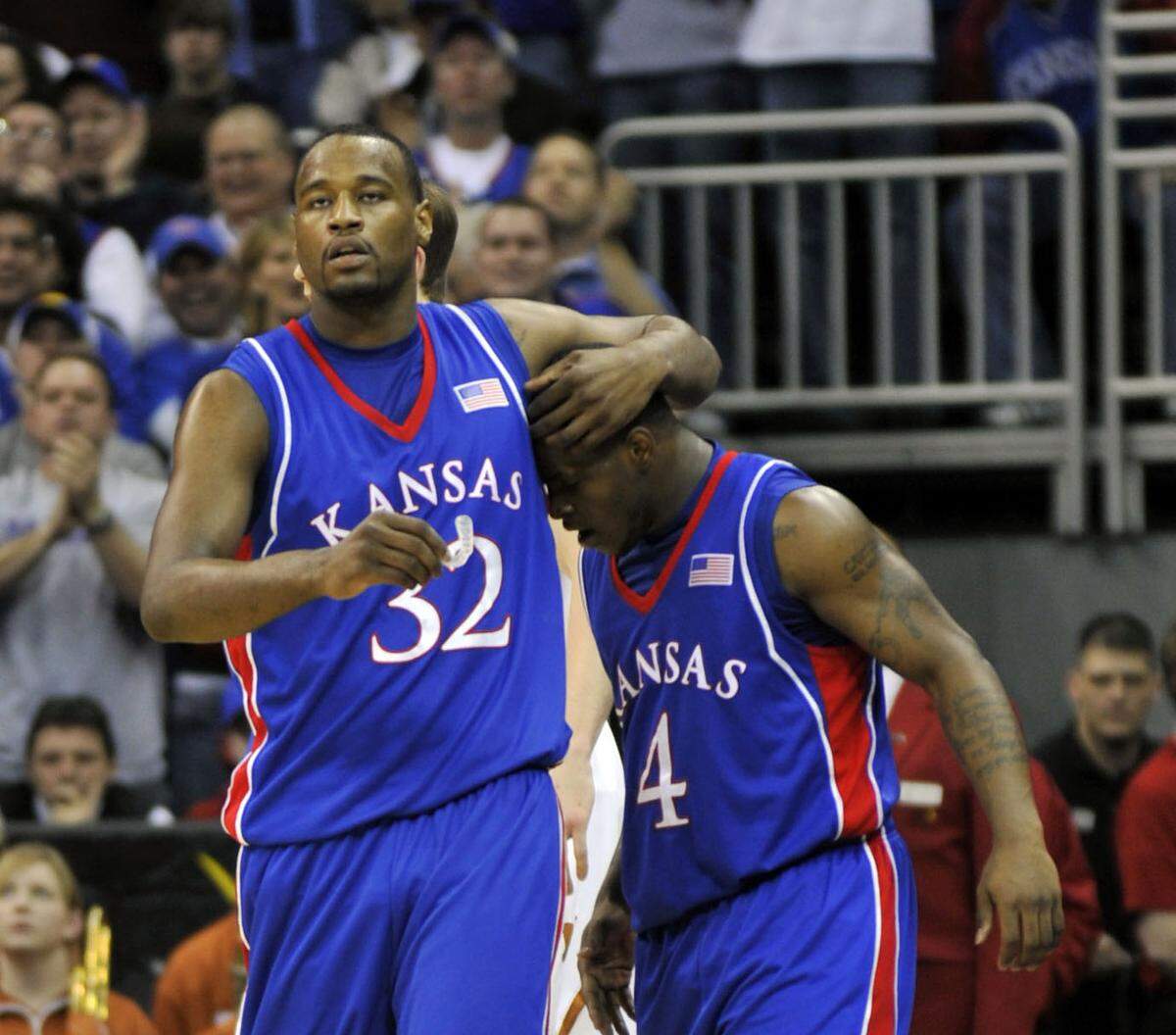 Kansas Jayhawks forward Darnell Jackson (32) warps his arm around guard Sherron Collins (4) late in the second half against the Texas Longhorns during the 2008 Big 12 Tournament championship game at Sprint Center (now T-Mobile Center).