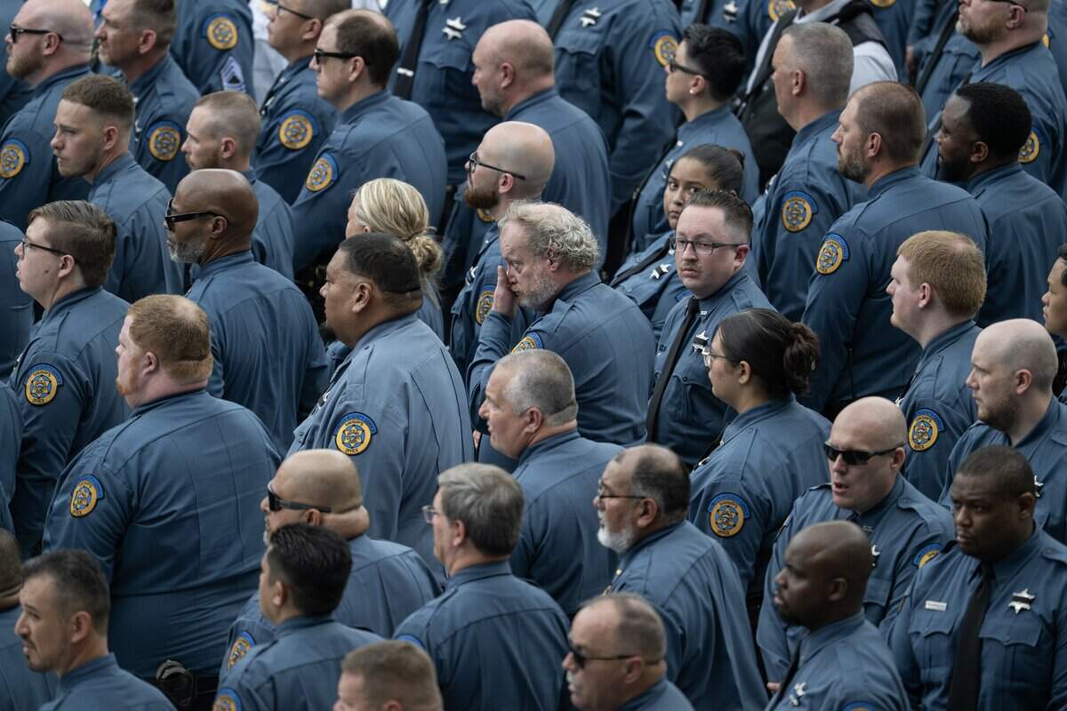A first responder wipes away tears as the funeral service for Deputy Elijah Ming comes to a close at Children's Mercy Park on Monday, Aug. 11, 2025, in Kansas City, Kansas.